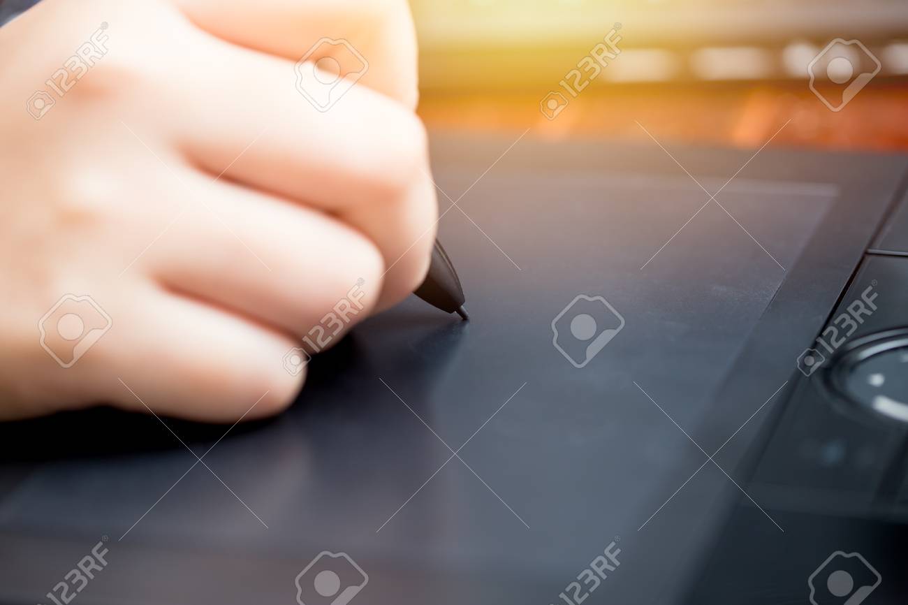 closeup hand using stylus pen digital artist working or retouch