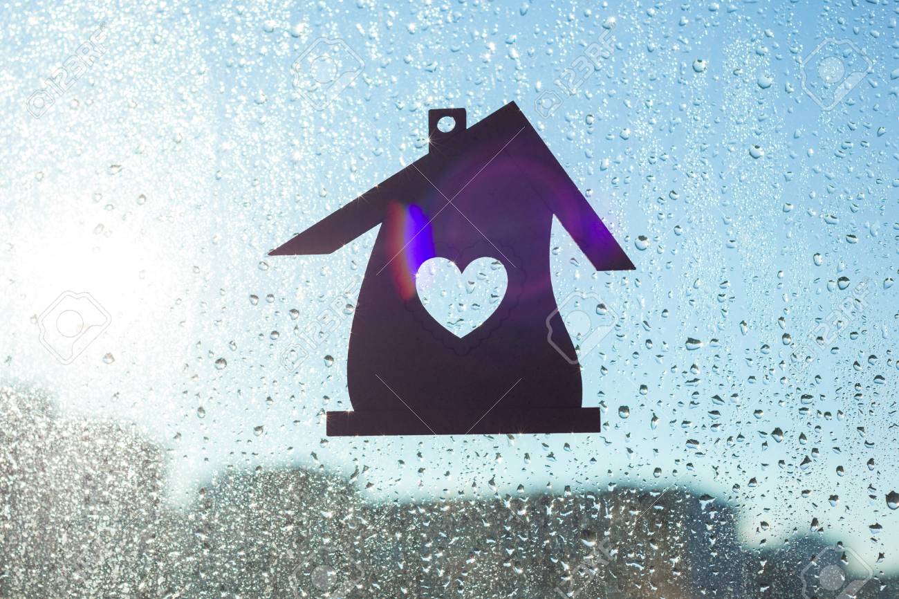ホームスウィートホーム 雨の日当たりの良い滴と窓の背景にハートの形を持つホームシンボル の写真素材 画像素材 Image