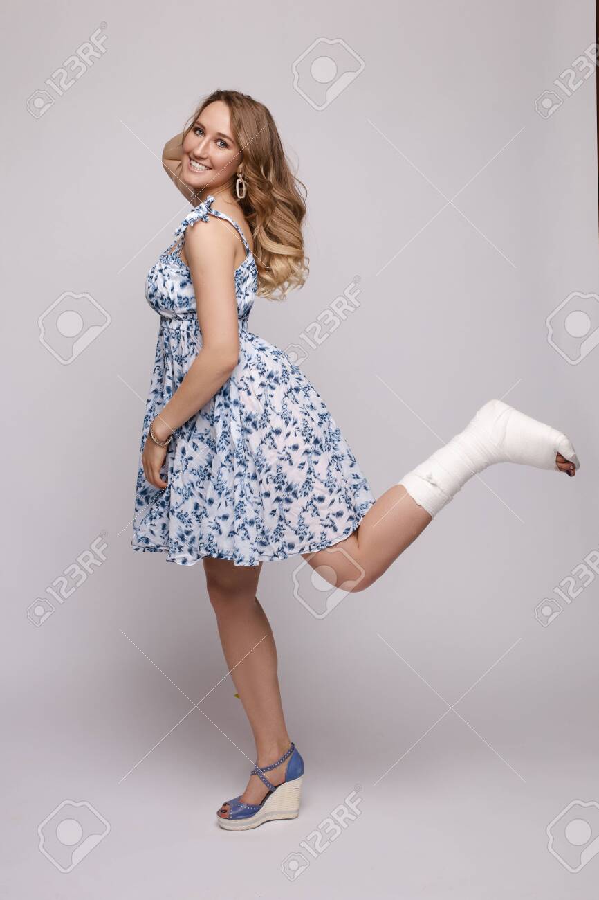 Pretty Woman In Short Dress Posing With Broked Leg Stock Photo Picture And Royalty Free Image Image