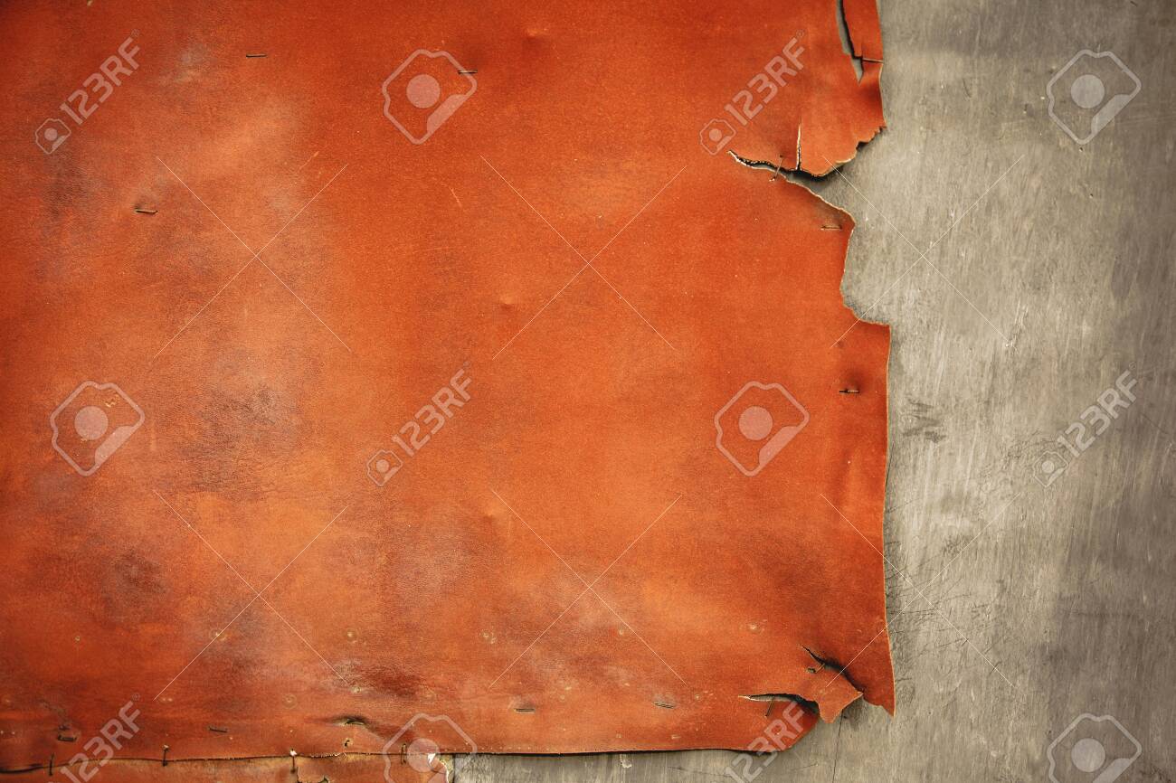 Pieces Of Old, Worn Leather With Ragged Edges On The Charred Wall.  Background In Retro Style. Frayed Texture In Orange Gray Tones Stock Photo,  Picture and Royalty Free Image. Image 143834381., image size:1300x866