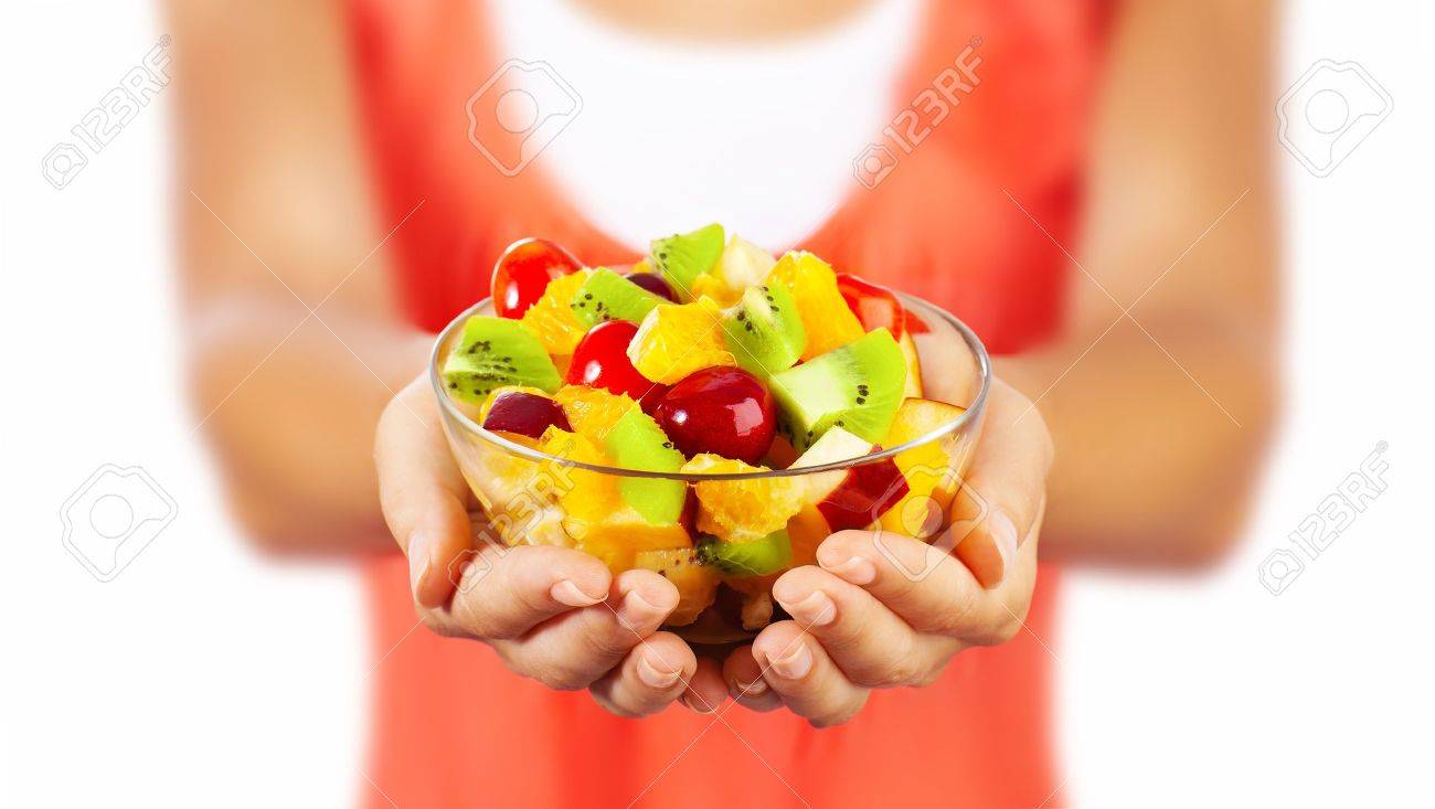 Healthy mix fruit salad, closeup on fresh summer dessert, woman holds lunch bowl, selective focus on female hands, eating girl shallow dof, body weight care, health and diet concept - 13791832 Healthy mix fruit salad, closeup on fresh summer dessert, woman holds lunch bowl, selective focus on female hands, eating girl shallow dof, body weight care, health and diet concept - 13791832