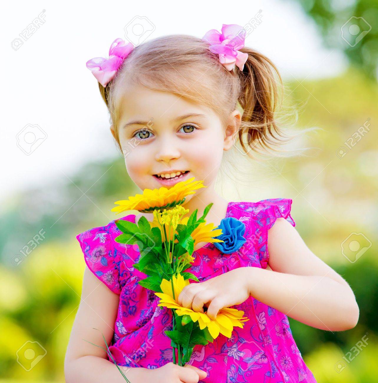 Cute Child Holding Fresh Sunflower Flowers Stock Photo, Picture and Royalty  Free Image. Image 18522019.