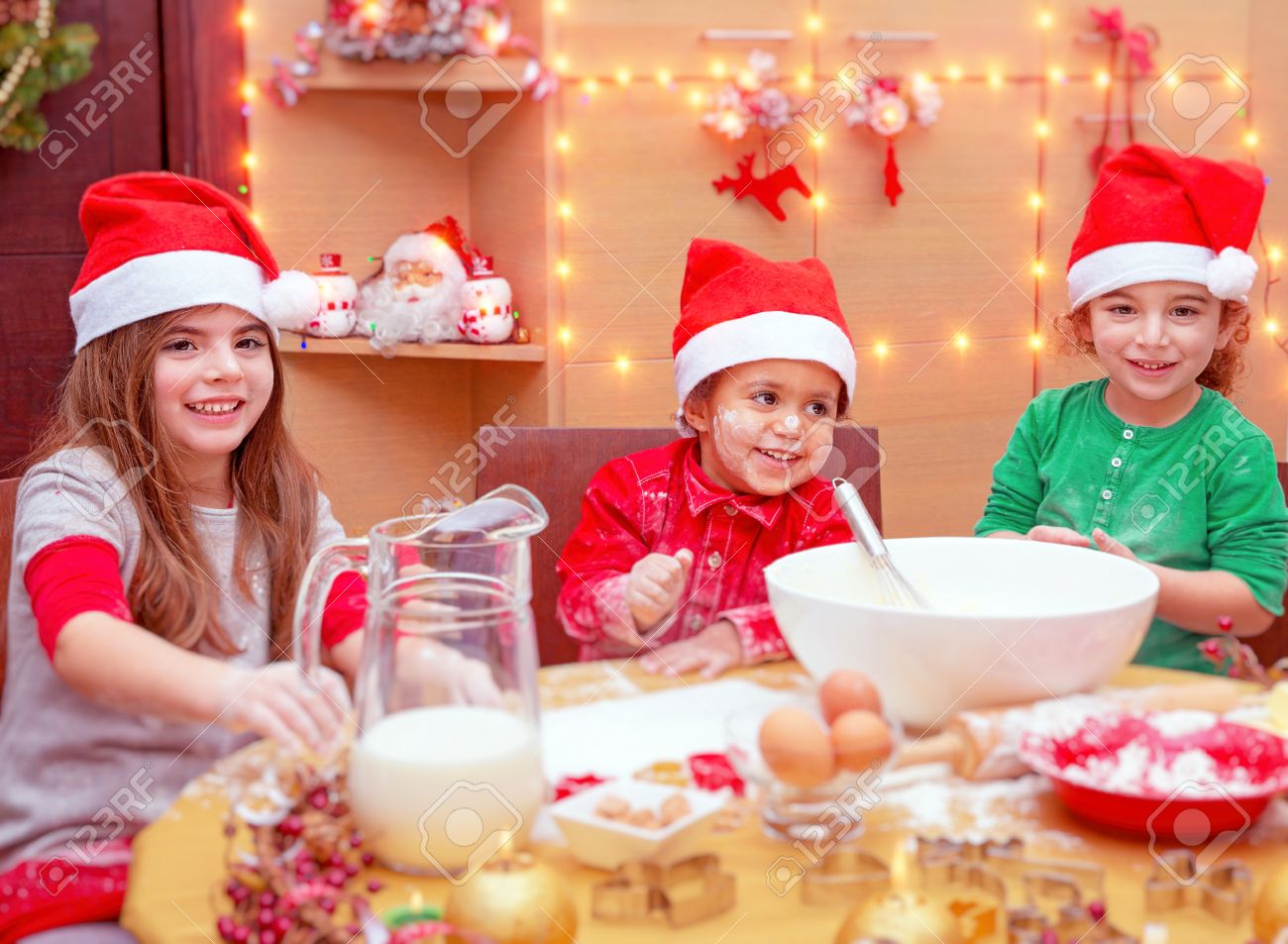 happy children making christmas cookies at home three cute little kids wearing red santa hats - Making Christmas Cookies happy children making christmas cookies at home three cute little kids wearing red santa hats - Making Christmas Cookies