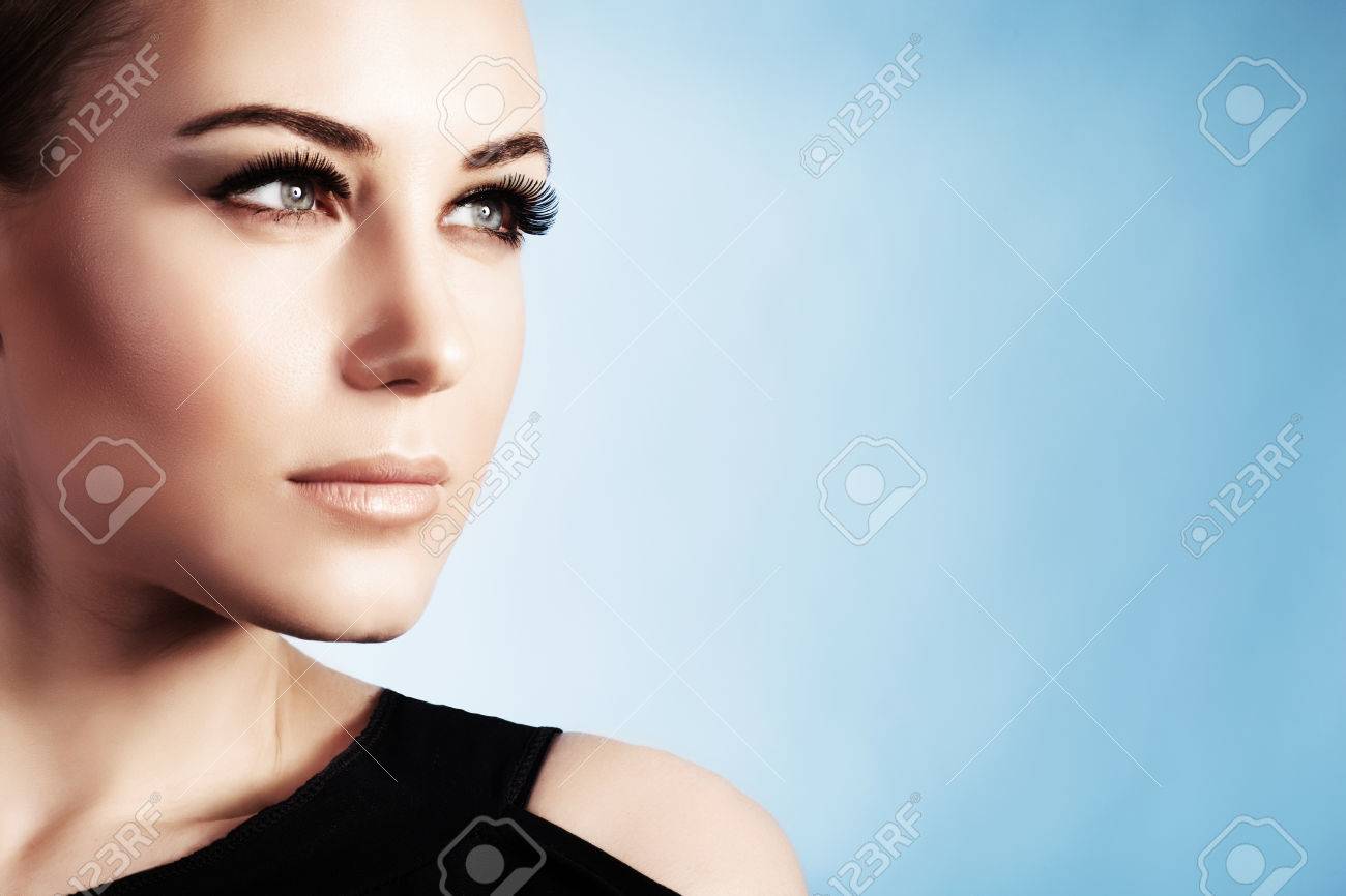 Closeup portrait of a beautiful woman isolated on blue background, gorgeous girl with perfect makeup, good looking model - 71442309 Closeup portrait of a beautiful woman isolated on blue background, gorgeous girl with perfect makeup, good looking model - 71442309