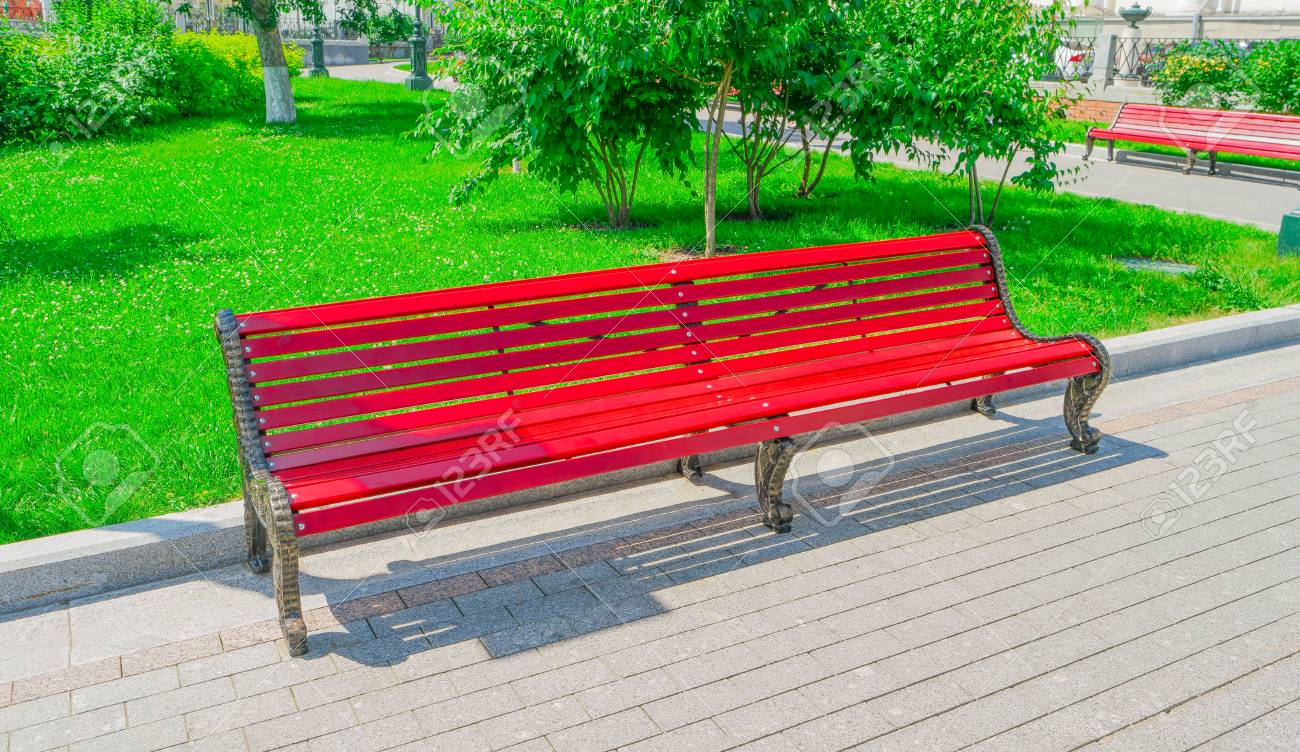 old red wooden bench in city park stock photo picture and royalty