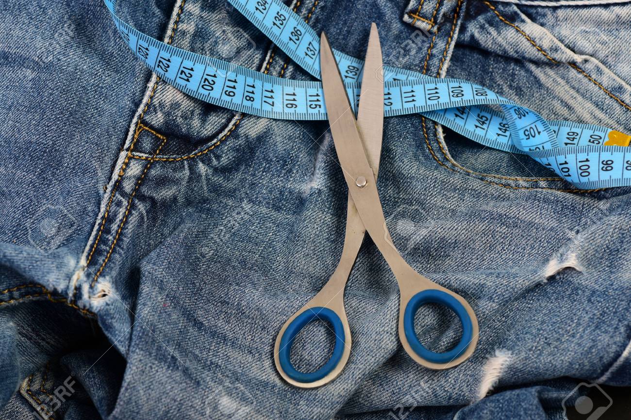 tailors tools on denim textile making clothes and design concept