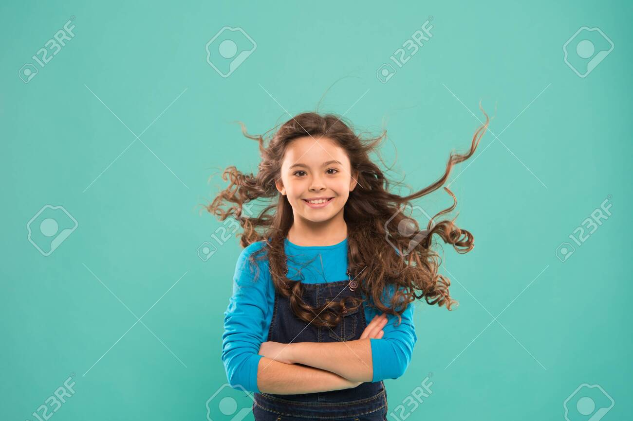 Just Amazing Happy Child With Long Curly Hair On Blue Background