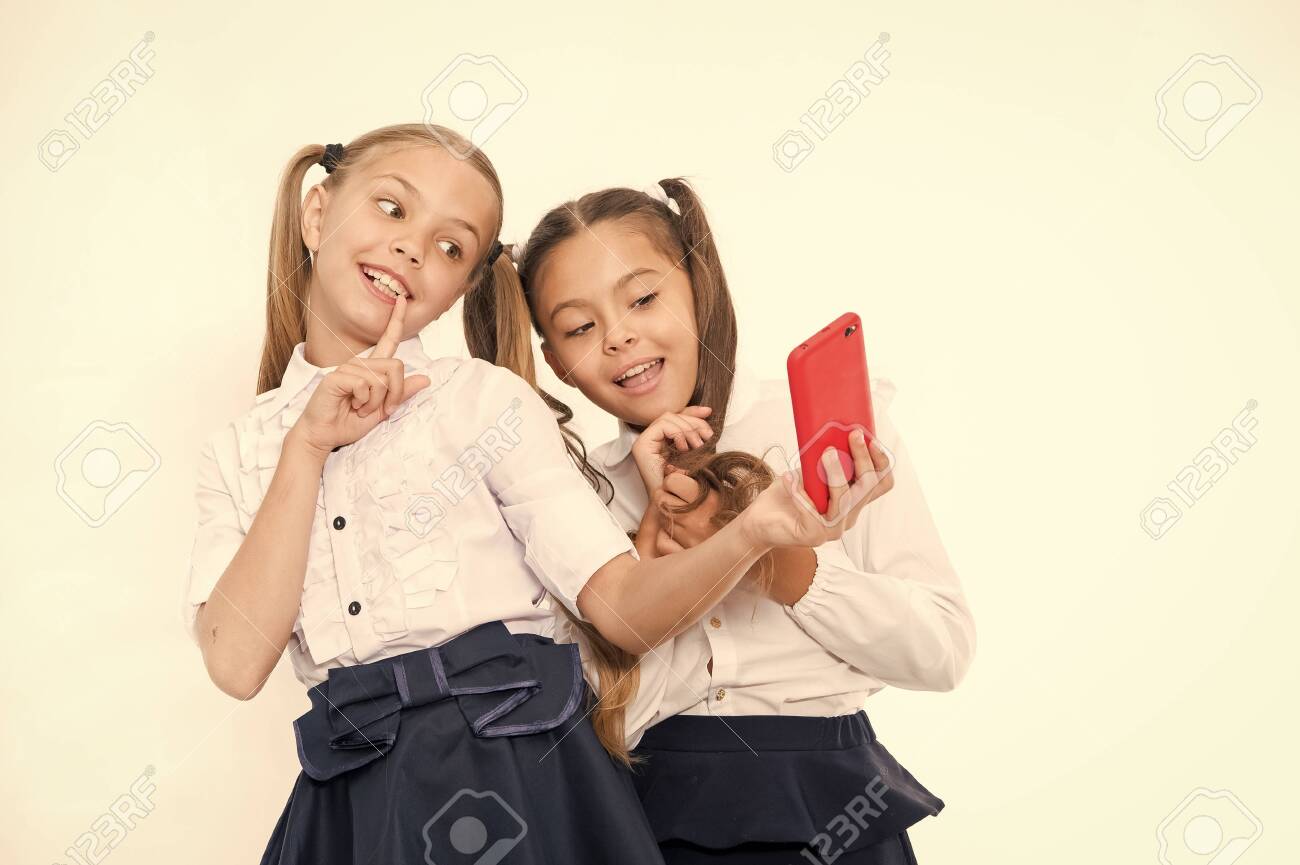 Girls School Uniform Take Selfie Smartphone. Posing To Take Perfect Photo.  Girlish Leisure. Girls Just Want To Have Fun. Schoolgirls Cute Hairstyle  Use Mobile Phone Or Smartphone To Share Photos Stock Photo,