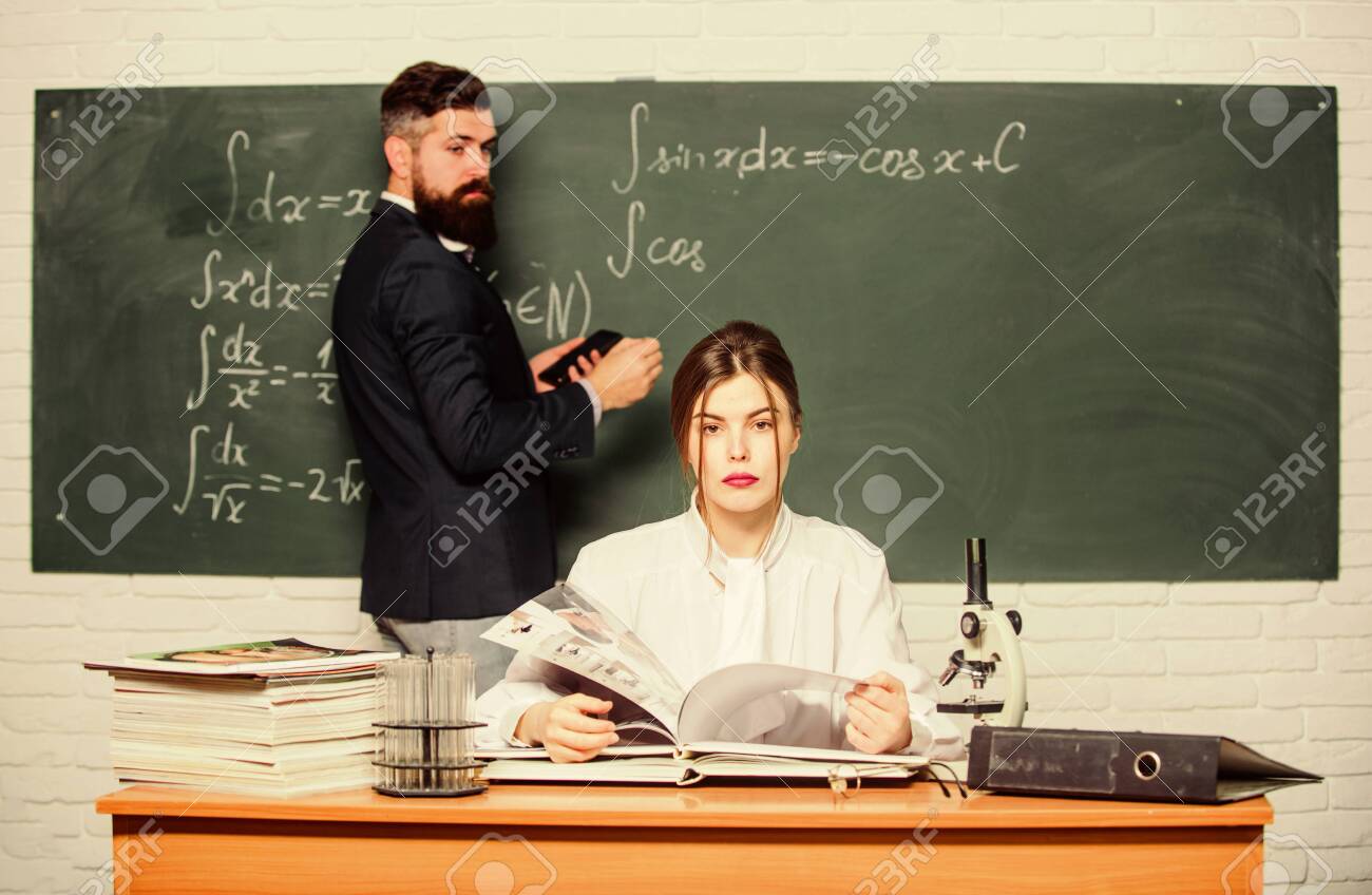 High School. Solving Task. Man Writing On Chalkboard Math Formulas. Teaching  In University. University Education. Knowledge Transfer. Teacher And  Student Near Chalkboard. College University Education Stock Photo, Picture  and Royalty Free Image.