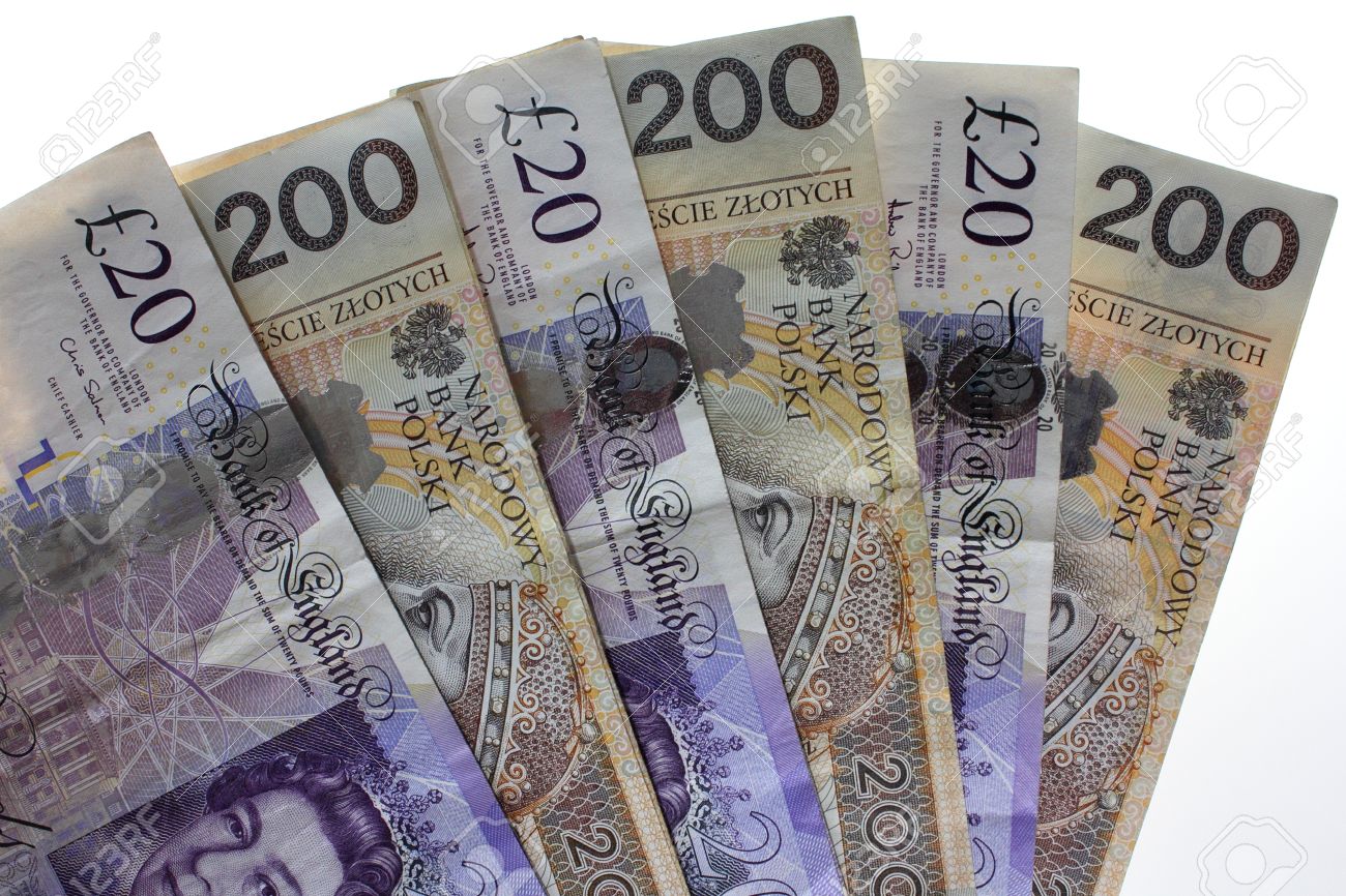 fanning twenty pound sterling and polish zloty banknotes stock photo