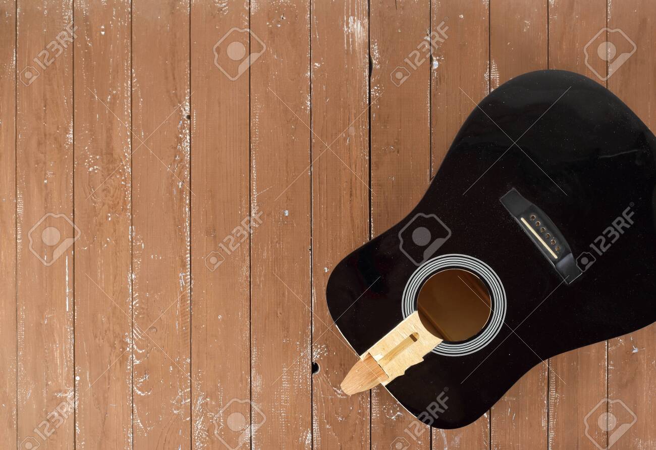 Guitar repair and service - broken sound board acoustic guitar top view wooden background - 128715185 Guitar repair and service - broken sound board acoustic guitar top view wooden background - 128715185