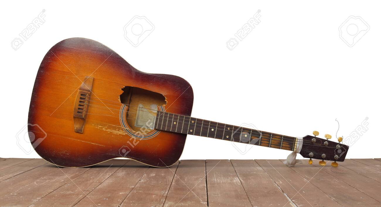 Musical instrument - Front view broken classic acoustic guitar on a white wall - 144386390 Musical instrument - Front view broken classic acoustic guitar on a white wall - 144386390