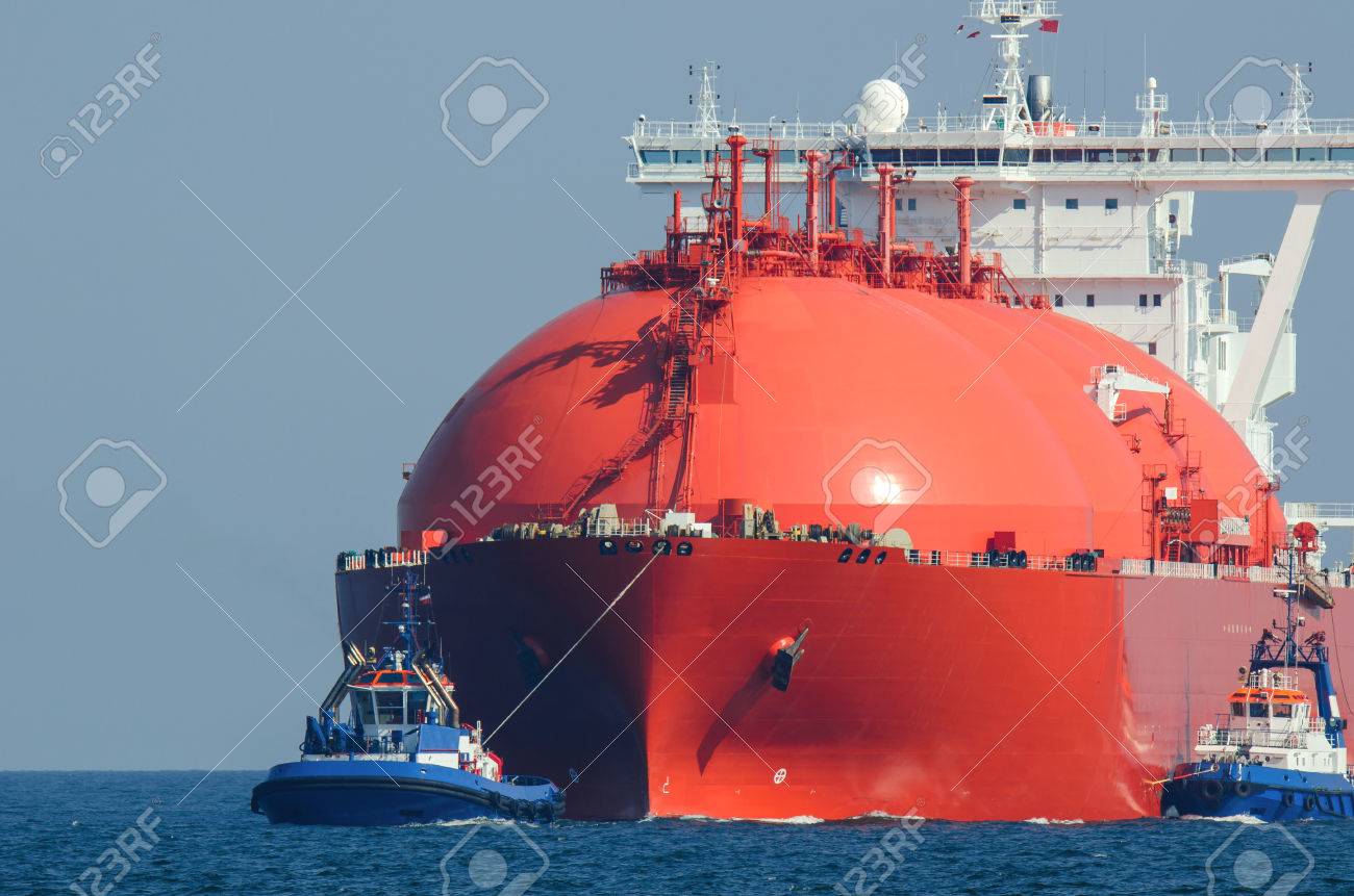 LNG TANKER AT SEA. Large tanker flows for the escort tugs - 64043348 LNG TANKER AT SEA. Large tanker flows for the escort tugs - 64043348