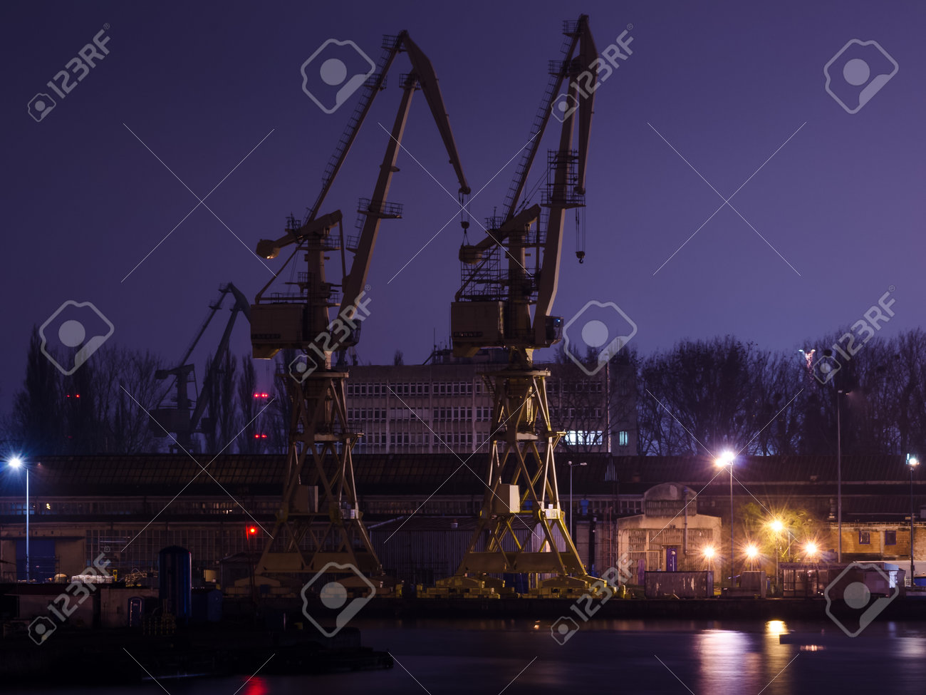 SZCZECIN, WEST POMERANIAN - POLAND - 2020: Shipyard cranes and quays at night - 168633088 SZCZECIN, WEST POMERANIAN - POLAND - 2020: Shipyard cranes and quays at night - 168633088