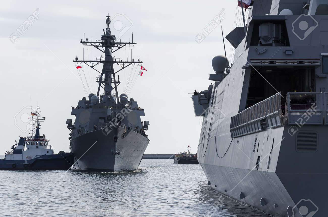 WARSHIPS - An Italian frigate and an American destroyer moored at a seaport wharf - 170922856 WARSHIPS - An Italian frigate and an American destroyer moored at a seaport wharf - 170922856