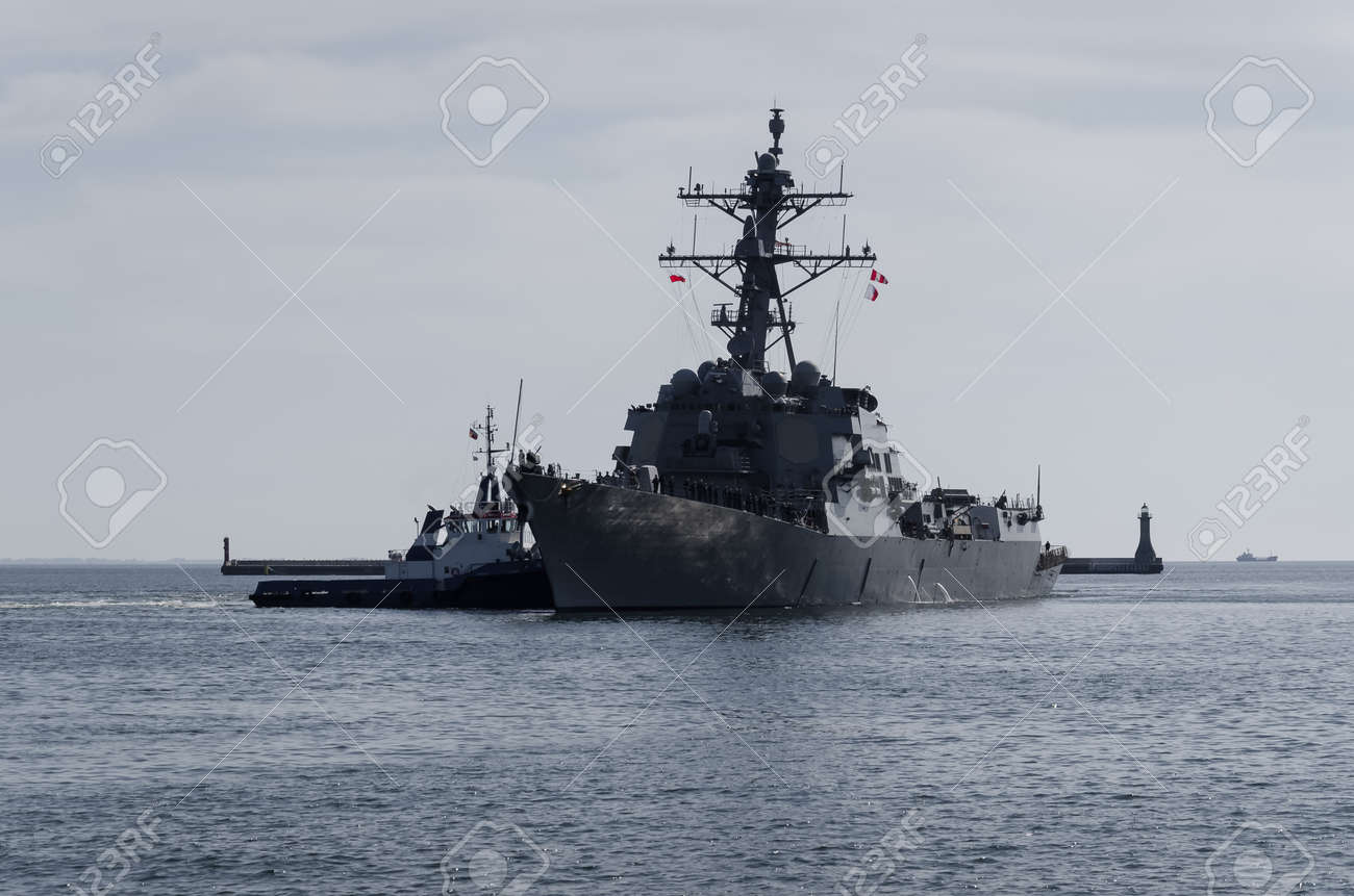 WARSHIP - US Navy guided missile destroyer maneuvers in the port assisted by a tugboat - 170922864 WARSHIP - US Navy guided missile destroyer maneuvers in the port assisted by a tugboat - 170922864