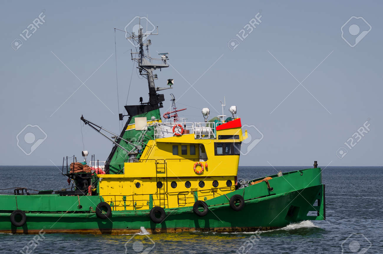 TUGBOAT - Auxiliary vessel is sailing on the background of breakwater - 171651617 TUGBOAT - Auxiliary vessel is sailing on the background of breakwater - 171651617