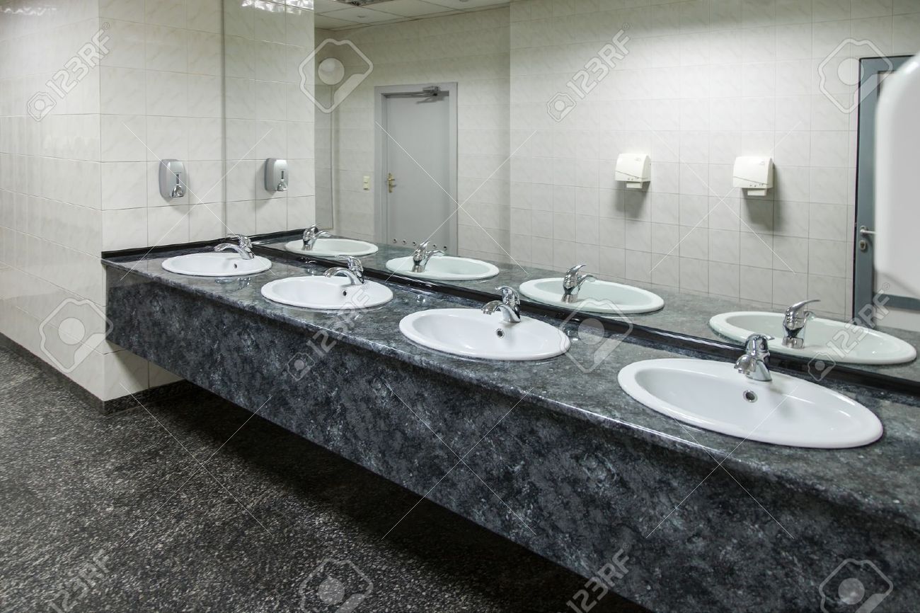 Public Bathroom Sink row of wash basins with mirrors in public toilet stock photo Public Bathroom Sink row of wash basins with mirrors in public toilet stock photo