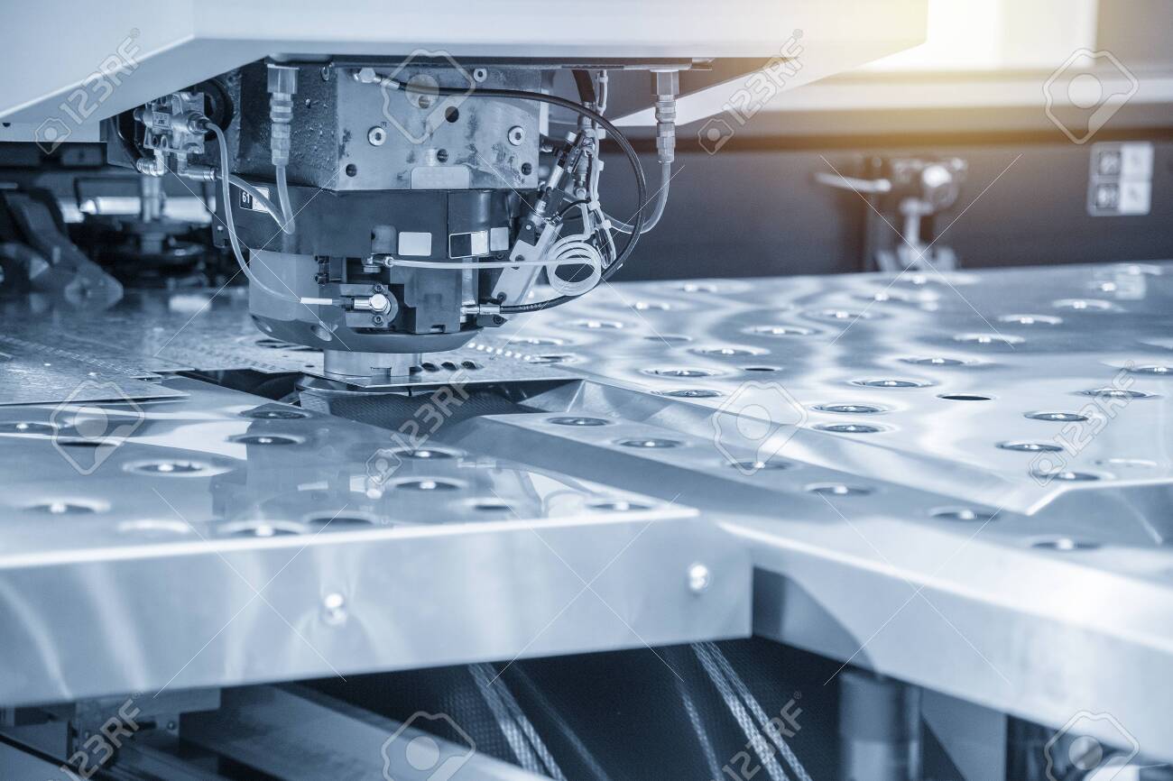 The hi-speed CNC punching machine in light blue scene. Modern metalworking manufacturing process by punching machine. - 124388940 The hi-speed CNC punching machine in light blue scene. Modern metalworking manufacturing process by punching machine. - 124388940