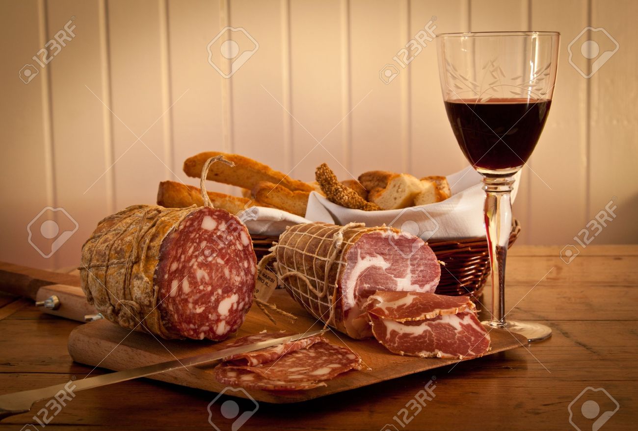 Delicious Mediterranean snack: red wine with salami and home-made bread. - 13868346 Delicious Mediterranean snack: red wine with salami and home-made bread. - 13868346