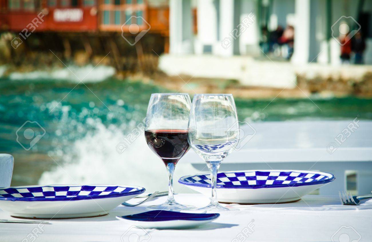 A table ready for a meal by the sea in Little Venice, Mykonos, Greece. - 13897256 A table ready for a meal by the sea in Little Venice, Mykonos, Greece. - 13897256