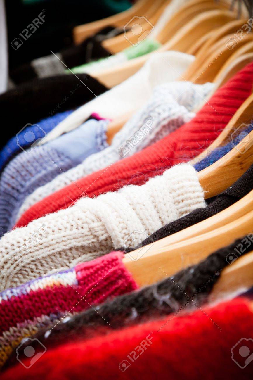 Close-up on a rack of second-hand jumpers and cardigans at a market in London recession bargains - 13899087 Close-up on a rack of second-hand jumpers and cardigans at a market in London recession bargains - 13899087