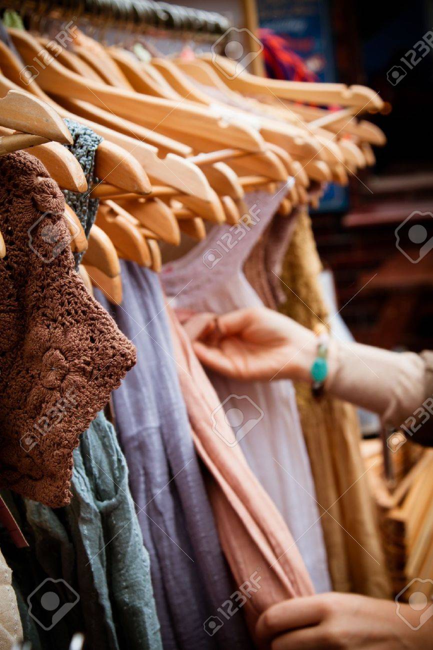 Recession bargains: rack of second-hand dresses for sale at market. Portrait orientation. - 20013135 Recession bargains: rack of second-hand dresses for sale at market. Portrait orientation. - 20013135