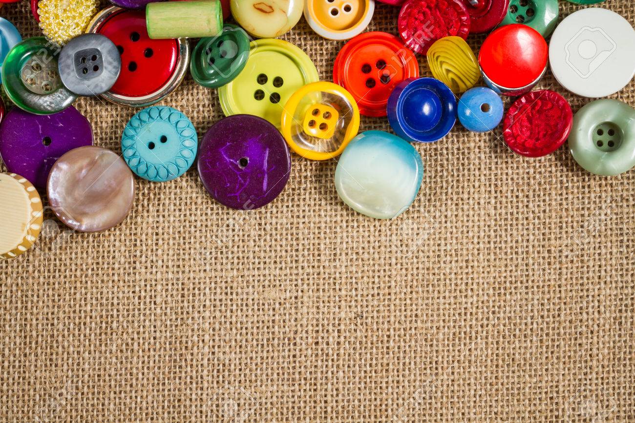 A great variety of colorful vintage buttons against a fabric background. Landscape orientation. Plenty of copy space. - 22441480 A great variety of colorful vintage buttons against a fabric background. Landscape orientation. Plenty of copy space. - 22441480