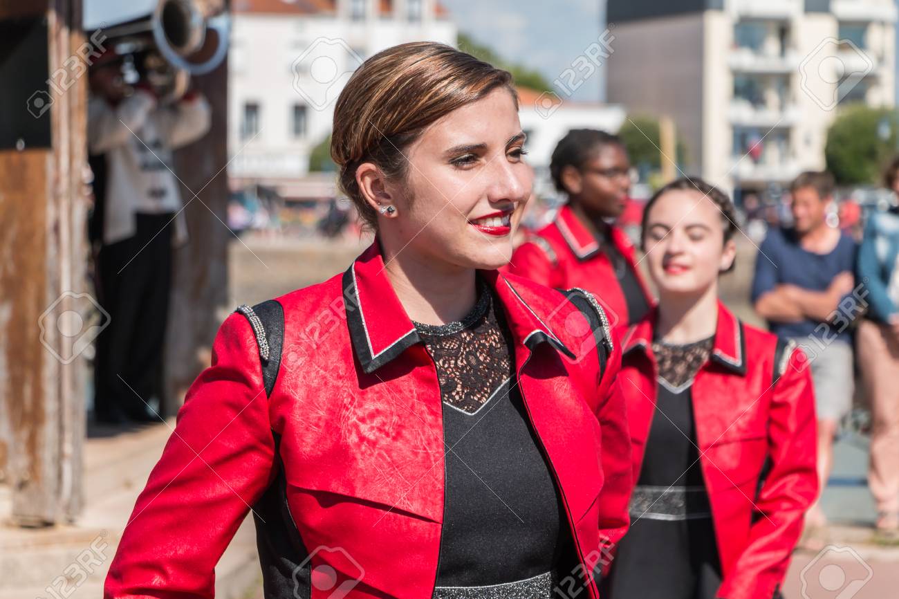 Saint Gilles Croix de Vie, France - July 14, 2016 : portait of fanfare dancing girl in the street that accompanies the musicians during the day of the French national day - 60285696 Saint Gilles Croix de Vie, France - July 14, 2016 : portait of fanfare dancing girl in the street that accompanies the musicians during the day of the French national day - 60285696