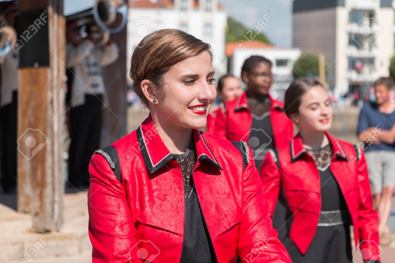Saint Gilles Croix de Vie, France - July 14, 2016 : portait of fanfare dancing girl in the street that accompanies the musicians during the day of the French national day - 60285701 Saint Gilles Croix de Vie, France - July 14, 2016 : portait of fanfare dancing girl in the street that accompanies the musicians during the day of the French national day - 60285701