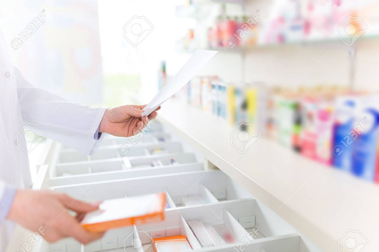 Pharmacist filling prescription in pharmacy - 55952306 Pharmacist filling prescription in pharmacy - 55952306