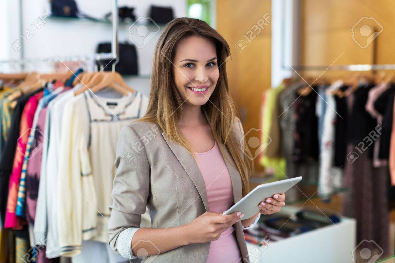 Boutique owner using a digital tablet - 57749965 Boutique owner using a digital tablet - 57749965