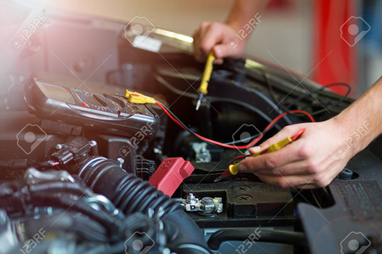 Car Battery Voltage >> Auto Mechanic Checking Car Battery Voltage Stock Photo Picture And Car Battery Voltage >> Auto Mechanic Checking Car Battery Voltage Stock Photo Picture And