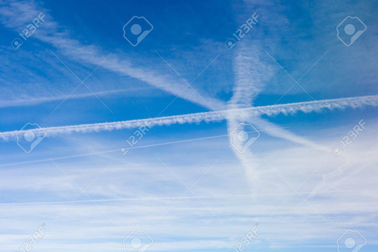 lots of criss crossing aircraft vapor trails in the blue sky stock vapor trails