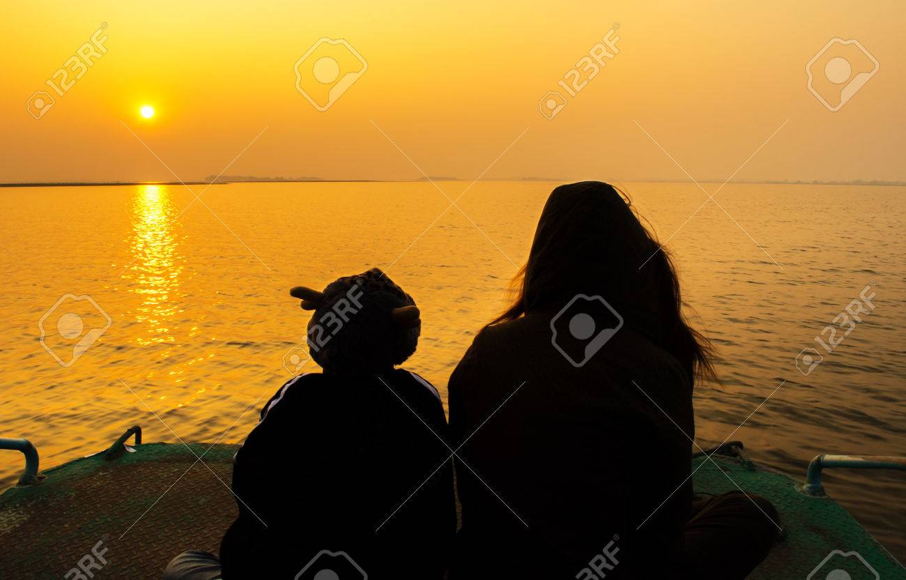 Mom And Son Silhouette In The Sunset On The Boat Stock Photo