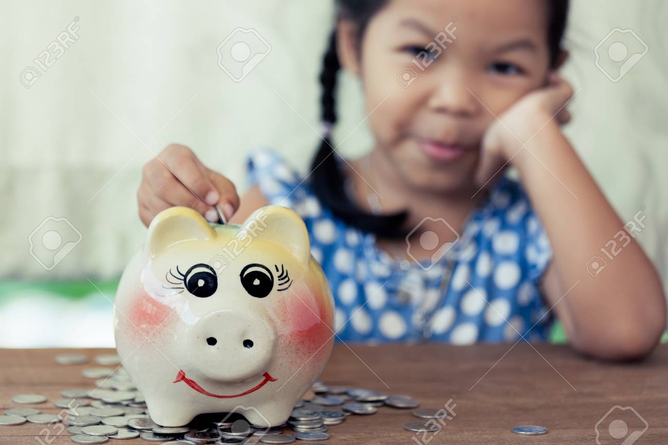 kids saving piggy bank ceramic child asian little girl putting coin into piggy bank in vintage color tonekid saving asian little girl putting coin into in vintage kids saving piggy bank ceramic child asian little girl putting coin into piggy bank in vintage color tonekid saving asian little girl putting coin into in vintage