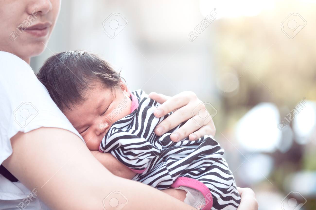 baby sleeping on chest of mother