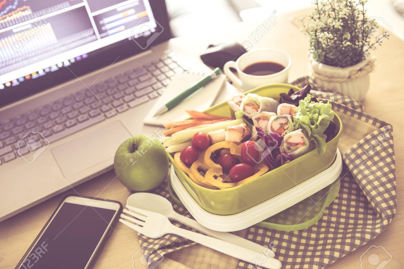 close up green lunch box on work place of working desk healthy