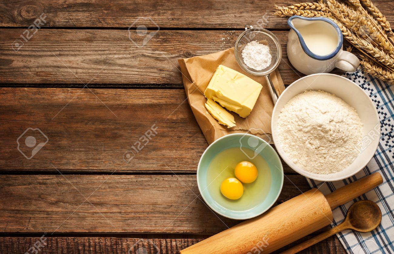 Baking cake in rural kitchen - dough recipe ingredients (eggs, flour, milk, butter, sugar) and rolling pin on vintage wood table from above. - 55317487 Baking cake in rural kitchen - dough recipe ingredients (eggs, flour, milk, butter, sugar) and rolling pin on vintage wood table from above. - 55317487