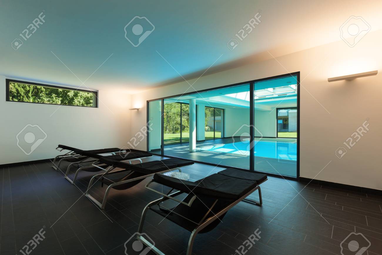 Indoor Swimming Pool Of A Modern House With Spa Room With Sunbeds