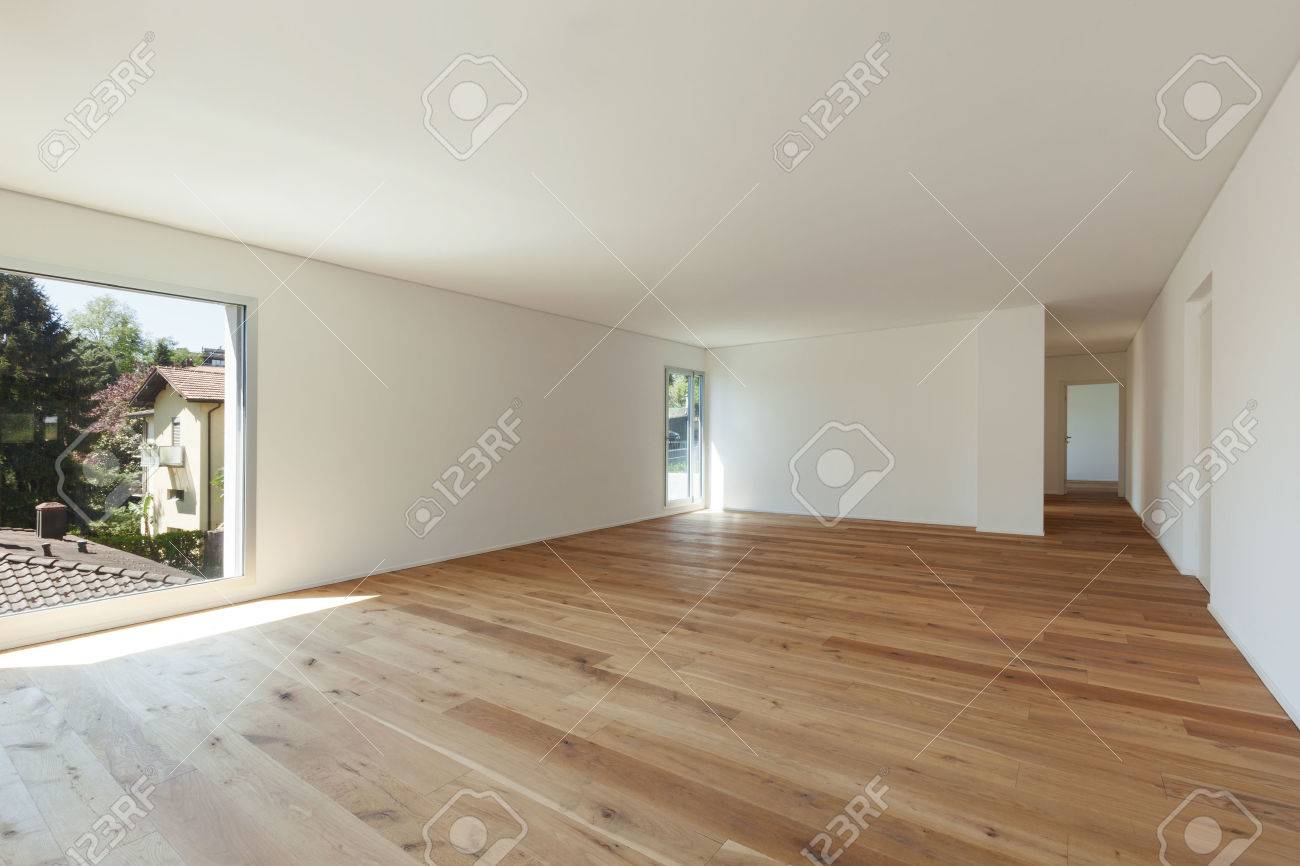 interior of empty apartment wide room with parquet floor and