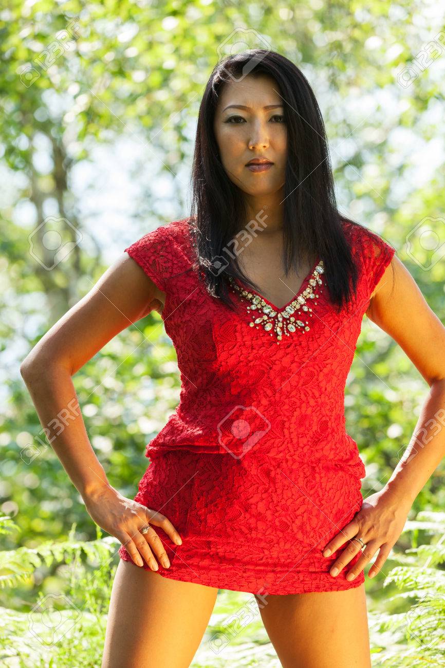 Photographer Alexandre ZveigerMature Asian Woman With Red Dress Stock