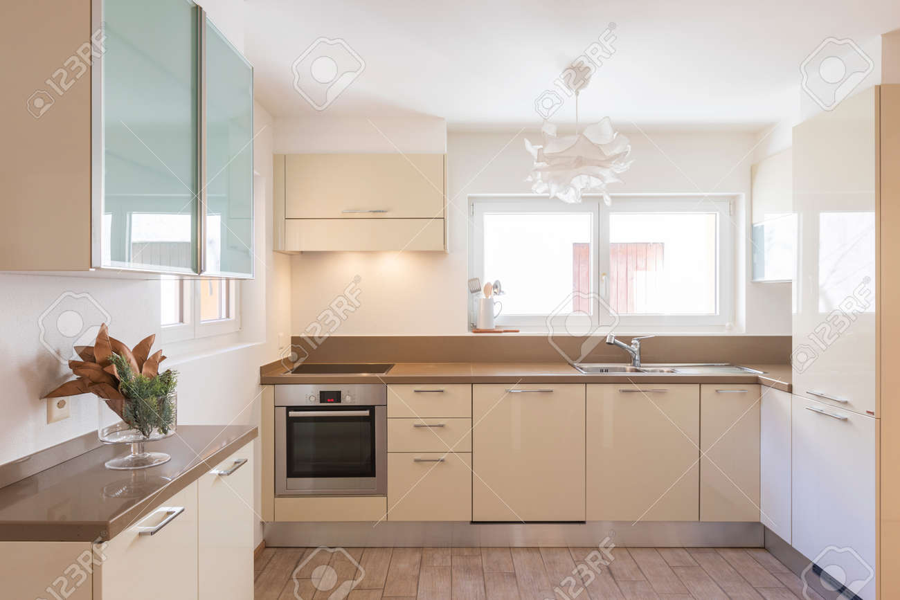 Clean and modern cream kitchen with large and bright windows. Nobody inside - 163078112 Clean and modern cream kitchen with large and bright windows. Nobody inside - 163078112