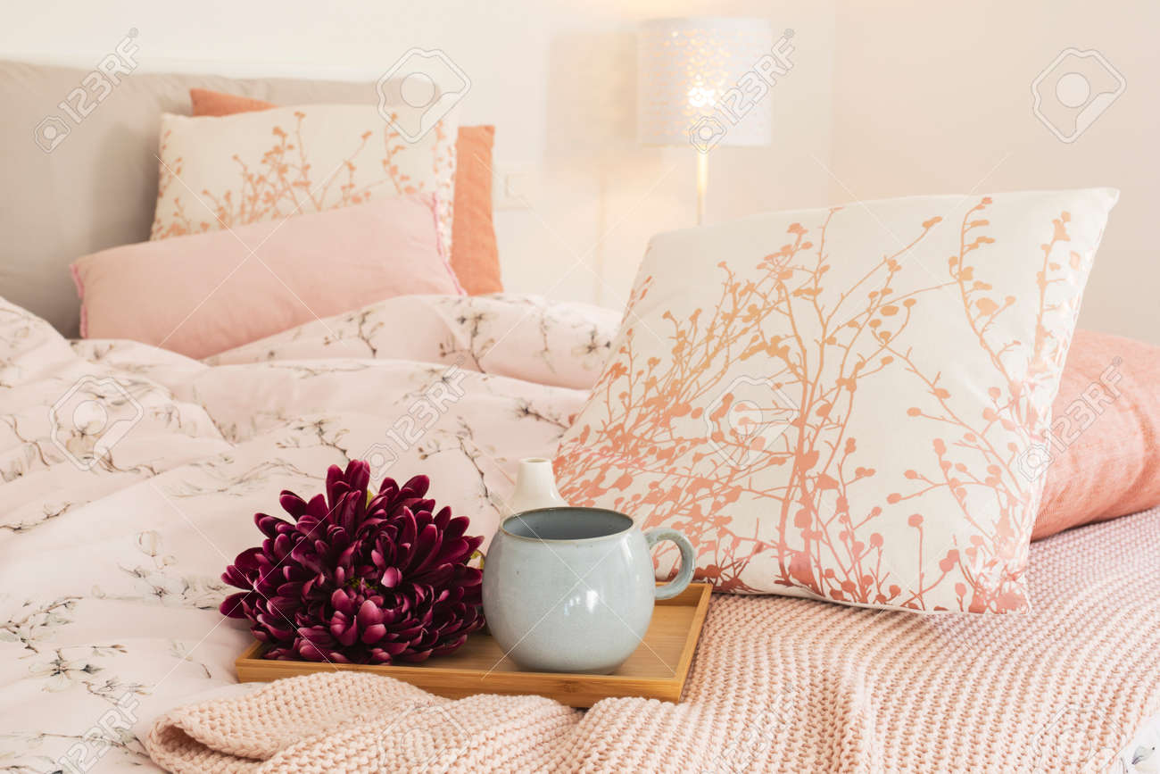 Close up of tray with flower and large cup ready to make breakfast. Tray put on the bed with large, fresh and clean pillows. - 163078149 Close up of tray with flower and large cup ready to make breakfast. Tray put on the bed with large, fresh and clean pillows. - 163078149