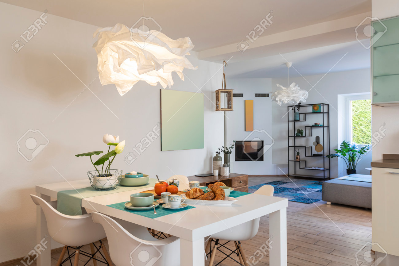 Elegant and romantic white table ready for breakfast with brioche, cups for coffee and fruits. Nobody inside - 163078164 Elegant and romantic white table ready for breakfast with brioche, cups for coffee and fruits. Nobody inside - 163078164
