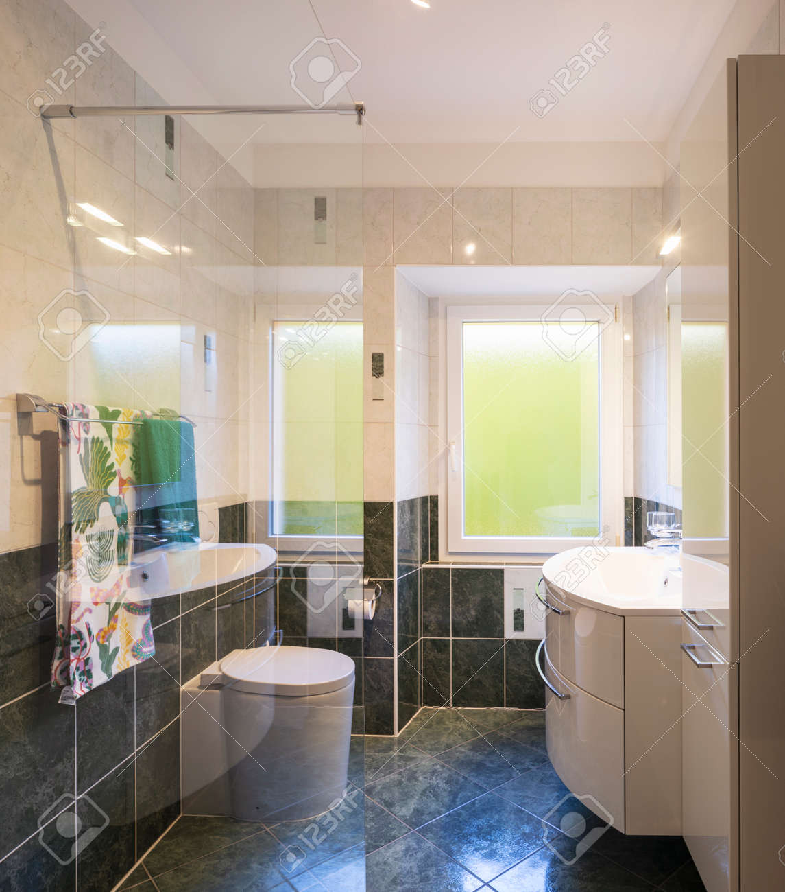 Bathroom with glass shower, tiles green and white. Large bright windows. Nobody inside. - 163079136 Bathroom with glass shower, tiles green and white. Large bright windows. Nobody inside. - 163079136
