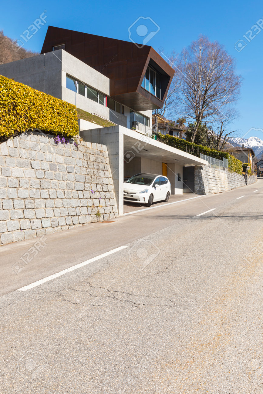 Exterior modern isolated villa, surrounded by nature. Iron and concrete cladding. Front road deserted. Nobody inside - 166462611 Exterior modern isolated villa, surrounded by nature. Iron and concrete cladding. Front road deserted. Nobody inside - 166462611