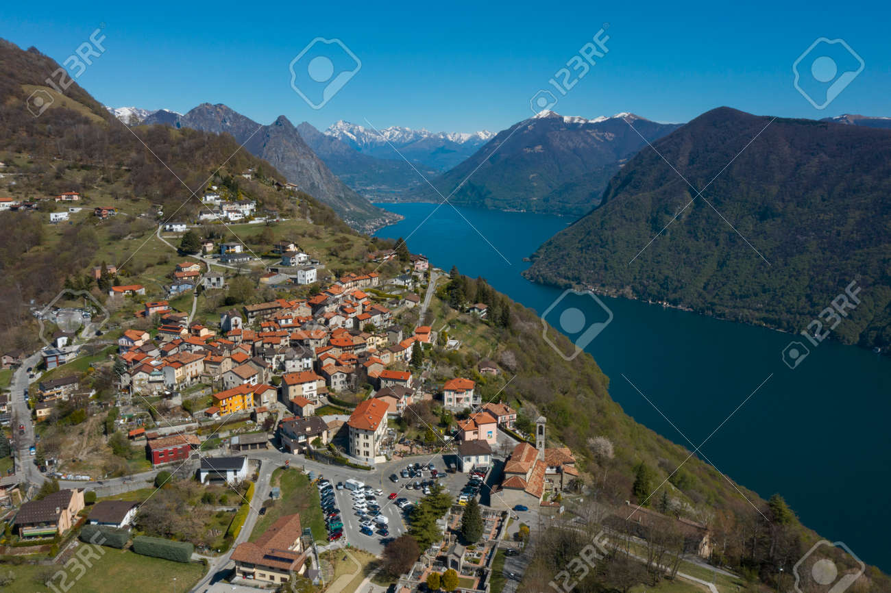 Aerial view of Lugano lake and the Monte Brè village in Canton Ticino in southern Switzerland. Sunny day - 170380125 Aerial view of Lugano lake and the Monte Brè village in Canton Ticino in southern Switzerland. Sunny day - 170380125