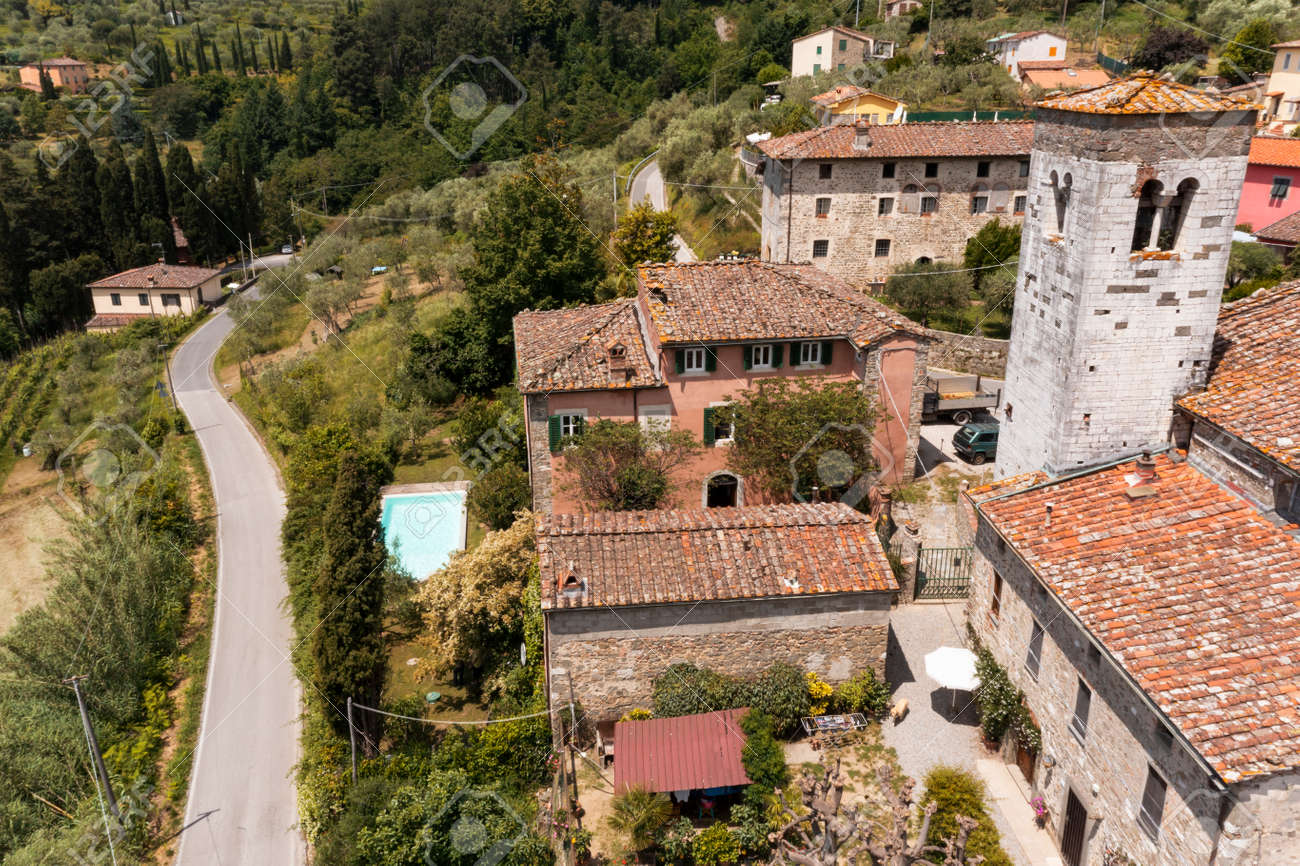 House or cottage in the middle of summer with a beautiful garden and swimming pool in Tuscany. The place is romantic and makes you dream. The shot was done with a drone. Italy always beautiful - 171332153 House or cottage in the middle of summer with a beautiful garden and swimming pool in Tuscany. The place is romantic and makes you dream. The shot was done with a drone. Italy always beautiful - 171332153