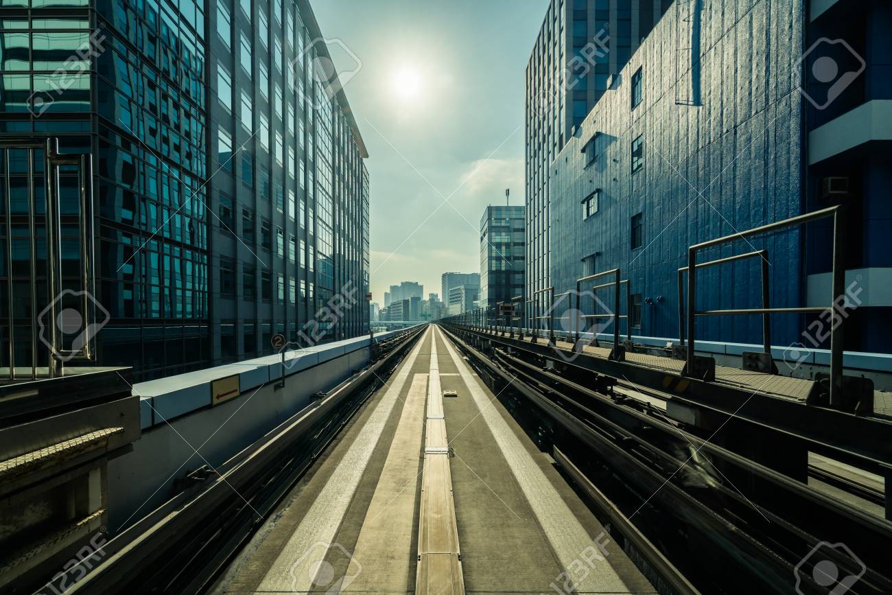 Front View Of Train In Modern City Straight Rail With Buildings